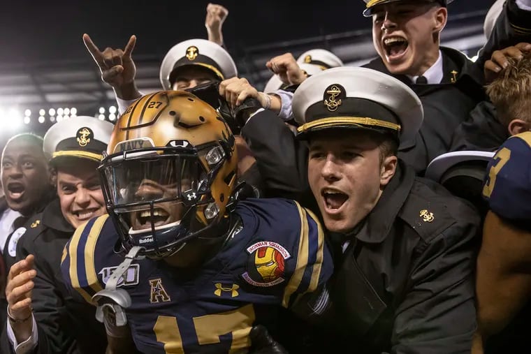 Navy cornerback Cameron Kinley celebrates with Navy Midshipmen after his team defeated Army, 31-7, in the 120th Army Navy game at Lincoln Financial Field in South Philadelphia on Saturday, Dec. 14, 2019.
