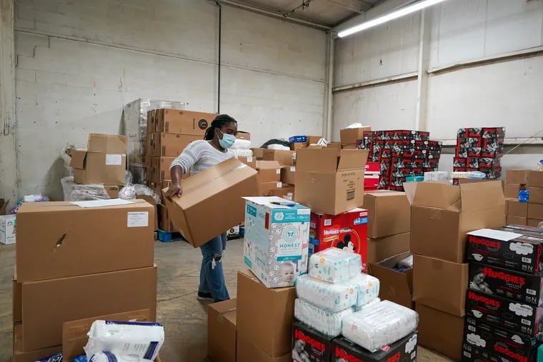 Deneen Newland puts together an order at the Greater Philadelphia Diaper Bank in Philadelphia on Thursday. The diaper bank has distributed over 7 million diapers and counting since its inception.