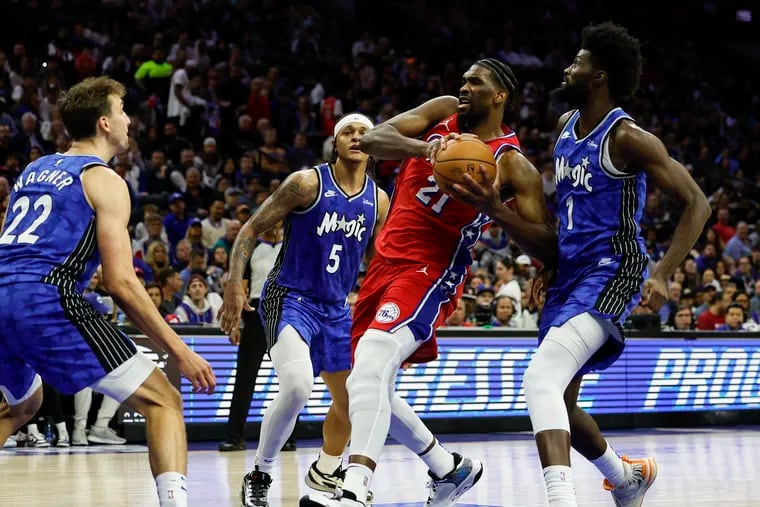 Joel Embiid (center) left the game after the driving to the basket late in the second quarter but returned to the court after halftime.