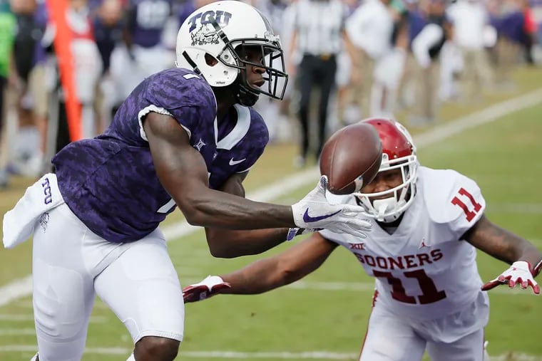 TCU wide receiver Jalen Reagor catches a touchdown pass against Oklahoma cornerback Parnell Motley.