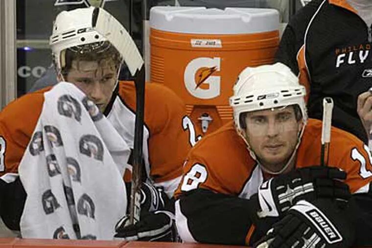 The Flyers' Claude Giroux, left, and Mike Richards sit during a third-period timeout against the Penguins. (Gene J. Puskar / AP)