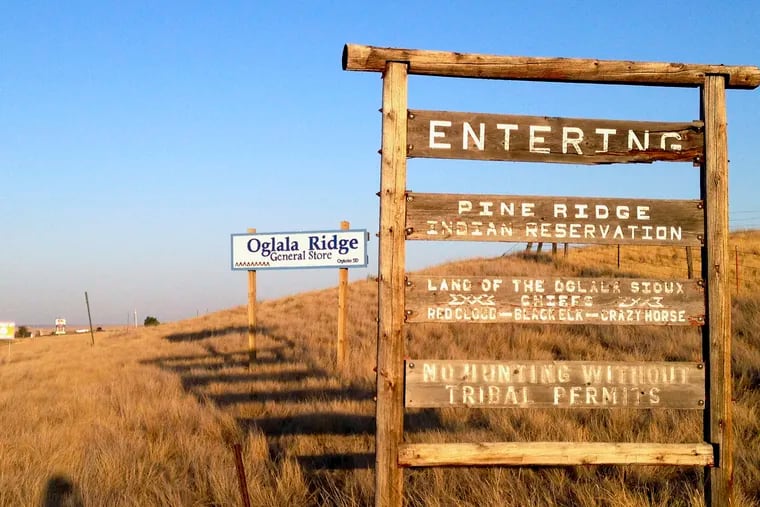 This Sept. 9, 2012, file photo shows the entrance to the Pine Ridge Indian Reservation in South Dakota, home to the Oglala Sioux tribe. Native American tribes across the U.S. for weeks have been shutting down casinos, hotels, and tourist destinations and shoring up services amid worries that the spread of the coronavirus quickly could overwhelm a chronically underfunded health-care system and affect a population that suffers disproportionately from cancer, diabetes, and some respiratory diseases.
