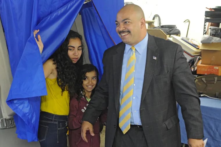 Philadelphia District Attorney Seth Williams is all smiles as he leaves the voting booth with his daughters Taylor, 13, and Hope, 9, after voting in the primary Tuesday at the 34th Ward, 34th Division. Williams was the 9th voter to vote, a little before 8 a.m. (Clem Murray / Staff Photographer)