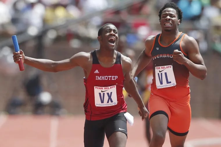 Kristian Marche, left, of Imhotep edges out Clifford Brinkley of Overbrook in the High School Boys' 4x400m Philadelphia Public League at the Penn Relays on April 29, 2017 at Franklin Field. CHARLES FOX / Staff Photographer
