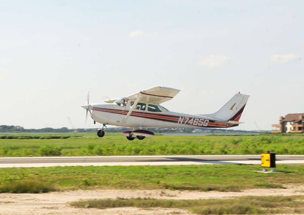 Small plane crashes into car after overshooting runway during