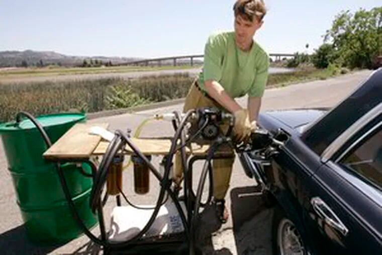 VALENTIN HUMER, president & CEO of Food & Vine, pumps recycled grapeseed oil into his Mercedes diesel yesterday in Napa, Calif. His company has both ends covered, and earns a green dividend: It sells gourmet grapeseed oil to upscale Napa Valley restaurants, then picks up the used oil to run the company cars.