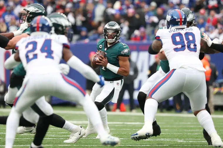 Eagles quarterback Jalen Hurts looks for a receiver during the first quarter against New York Giants on Sunday, November 28, 2021 at MetLife Stadium in East Rutherford, New Jersey.  Hurts threw an interception on the play.