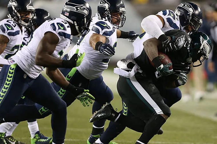 Eagles' LeSean McCoy is tackled by a host of Seahawks during the 2nd
quarter. Philadelphia Eagles play the Seattle Seahawks at Lincoln
Financial Field in Philadelphia on December 7, 2014. (David Maialetti/Staff Photographer)