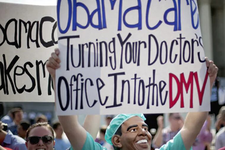 An opponent of President Barack Obama's health care law demonstrates outside the Supreme Court in Washington, Thursday, June 28, 2012, before the court's ruling on the law.  (AP Photo/David Goldman)