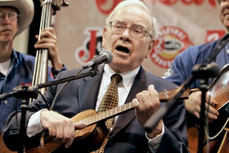 Chairman Warren Buffett played ukulele Saturday in Omaha, Neb., at the Berkshire Hathaway annual meeting. He told shareholders he&#0039;d like to &quot;sell something that I like to buy something huge I like even better.&quot;