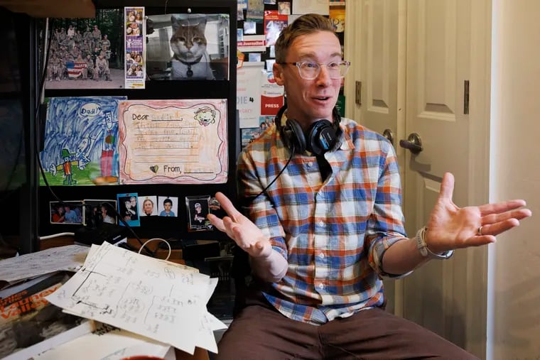 Matt Katz, host of the new podcast "Inconceivable Truth," photographed at his home office in Philadelphia. His hand-drawn family trees sit on the desk next to him.