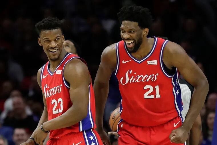Sixers guard Jimmy Butler and center Joel Embiid laugh late in the fourth-quarter against the Denver Nuggets on Friday, February 8, 2019 in Philadelphia.