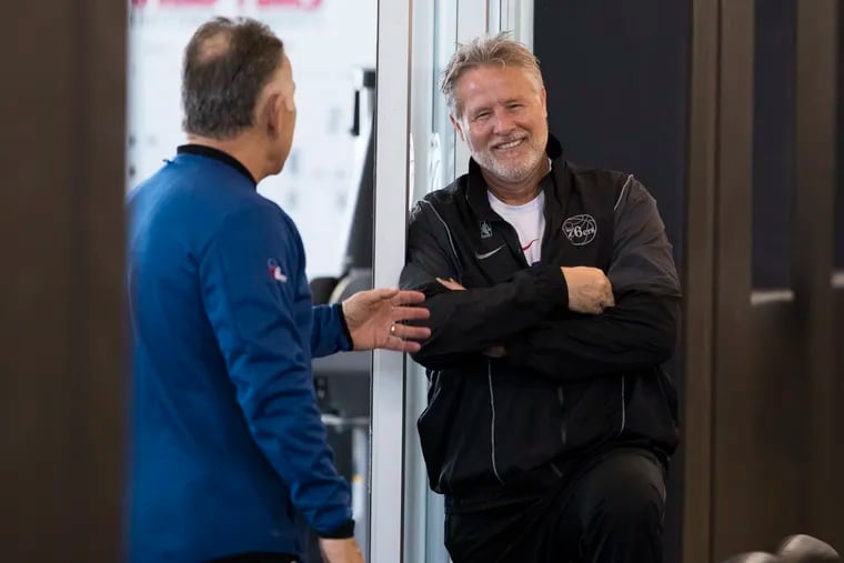 Sixers assistant coach Jim O'Brien, left, talks with coach Brett Brown before the start of Saturday's practice.