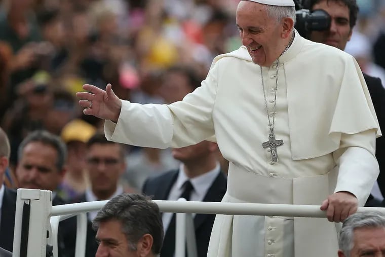 Pope Francis waves as he arrives in St Peter's Square at the Vatican for his weekly Papal Audience in Rome, Italy on June 24, 2015. (DAVID MAIALETTI / Staff Photographer)