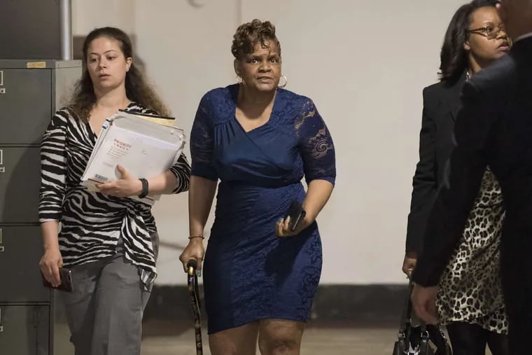 Gloria Byars (center) walks inside Philadelphia City Hall before entering Orphans Court Judge John Herron’s courtroom Monday, May 14, 2018. At right is her attorney, Sharon Alexander; at left is an assistant.