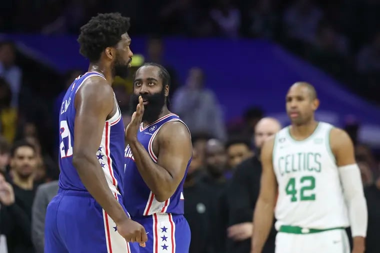 Sixers guard James Harden speaks to teammate Joel Embiid in the fourth quarter of a game against the Boston Celtics at the Wells Fargo Center in Philadelphia on Tuesday, April 4, 2023.
