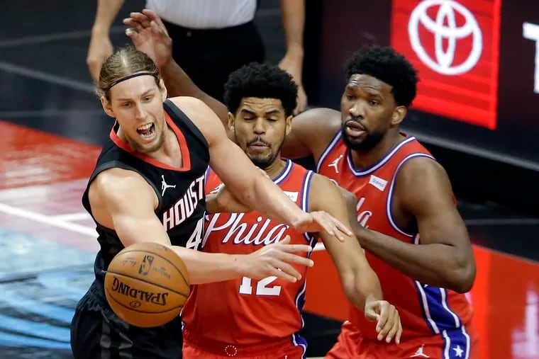 Houston Rockets forward Kelly Olynyk, left, loses the ball in front of 76ers forward Tobias Harris (12) and center Joel Embiid during the first half.