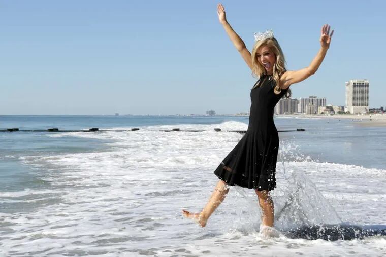 Miss America 2015, Kira Kazantsev of New York state, strolls in the Atlantic Ocean, part of a pageant tradition.