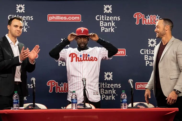 General manager Matt Klentak (left) and manager Gabe Kapler (right) welcomed outfielder Andrew McCutchen to the Phillies during a December press conference.