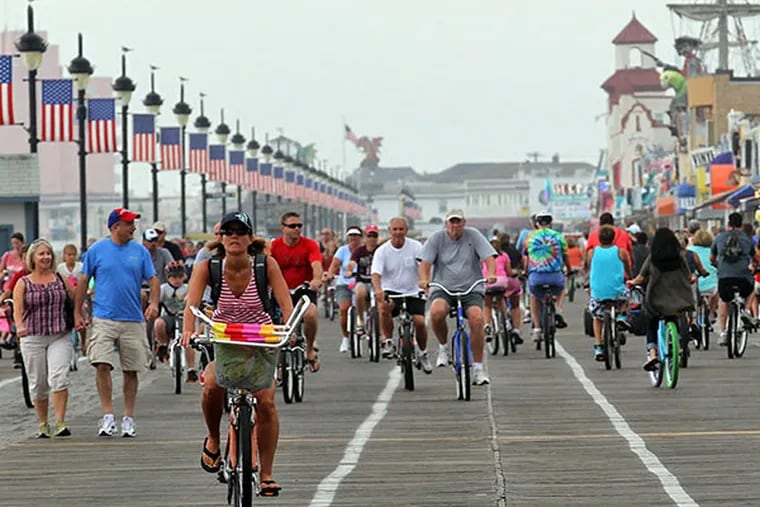 Pedestrians and bike riders on the Ocean City Boardwalk last September.  (Yong Kim / Staff Photographer)