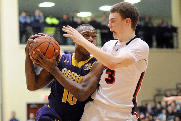 Roman Catholic's Tony Carr drives to the basket as Plymouth Whitemarsh's Oakley Spencer defends.