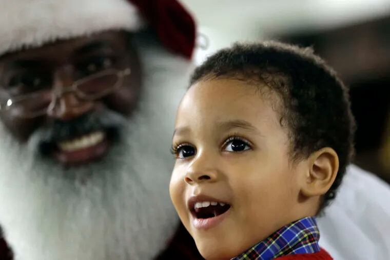 Dee Sinclair, a.k.a. the &quot;Real Black Santa,&quot; delights 4-year-old Joe Morris 4th in Atlanta. &quot;Kids don't see color. They see a fat guy in a red suit giving toys,&quot; he says.