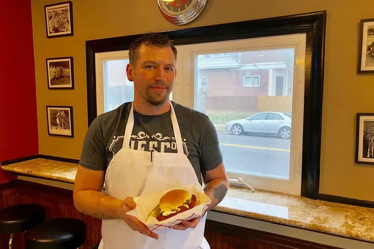 Kris Serviss with a Nashville hot chicken sandwich at Northeast Sandwich Co.
