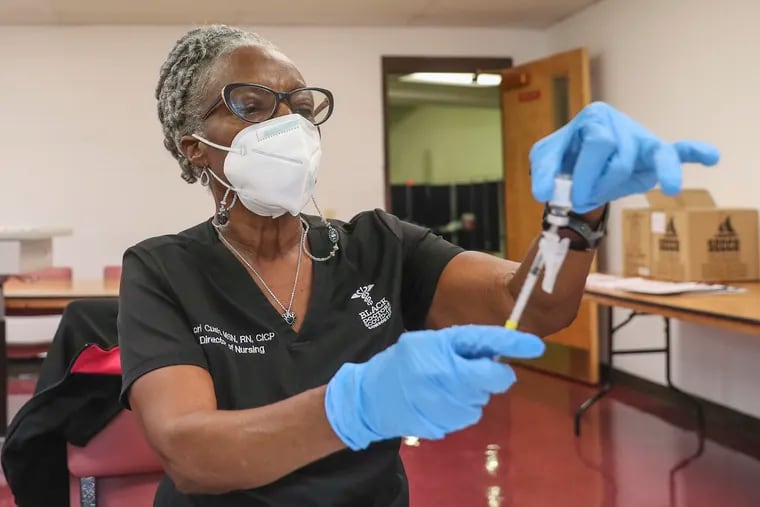 Dori Cush, director of nursing, prepares syringes with the monkeypox vaccine at the Dr. Ala Stanford Center for Health Equity in North Philadelphia on Wednesday. The Black Doctors Consortium hosted the clinic.