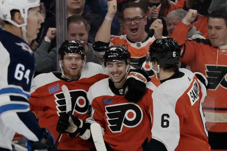 Flyers players celebrate a first-period goal by Morgan Frost (center) during its 4-1 win over Winnipeg at the Wells Fargo Center on Thursday.
