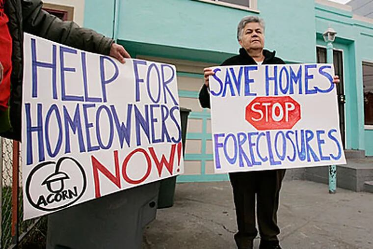Estela Jimenz, right, and other supporters of the Association of Community Organizations for Reform Now, protest outside a home under foreclosure in South San Francisco. (AP)