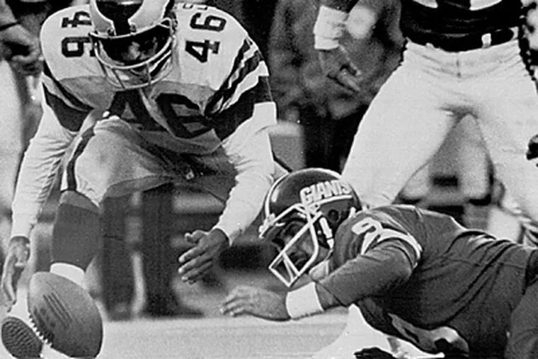 Herm Edwards (46) pounces on a ball fumbled by Giants quarterback Joe Pisarcik. Edwards ran into the end zone to cap off a 19-17 win in the "Miracle at the Meadowlands." (AP Photo/G. Paul Burnett, File)