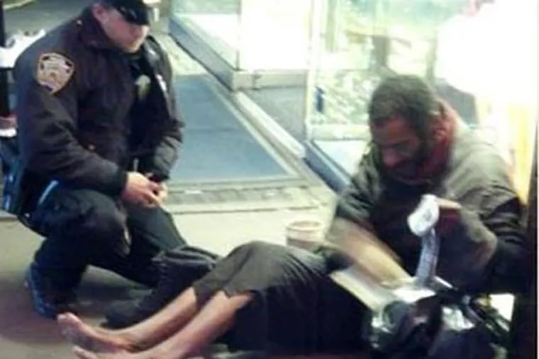 Arizona tourist Jennifer Foster took a photo of New York City Police Officer Larry DePrimo giving a homeless man boots in Times Square.