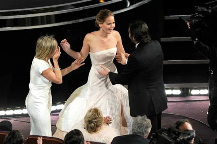 Karen Lawrence, left, and Bradley Cooper, right, congratulate Jennifer Lawrence after she was announced as the winner of the award for best actress in a leading role for "Silver Linings Playbook" during the Oscars at the Dolby Theatre on Sunday, Feb. 24, 2013, in Los Angeles. (Photo by Chris Pizzello/Invision/AP)