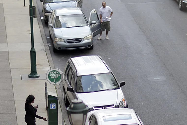 A customer uses a PPA parking kiosk on the 900 block of Filbert Street in Philadelphia. The PPA will resume enforcement at parking meters on June 8, the authority announced Friday.