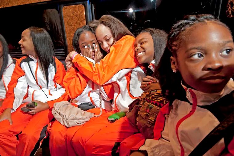 Members of the Camden Sophisticated Sisters take a limo to the airport to appear on Dancing with the Stars at 4 AM on 4/26/13. Destinee Williams,16, third from left, cries and gets a hug from Tina Baker, 16.  Next to Baker are Aijhanay Blakney, 12;  and at extreme right, Savannah Brooks, 9.  The two girls at left are Kyliah Walker, 15;  and Shaniyah Birch, 15.   ( APRIL SAUL / Staff )