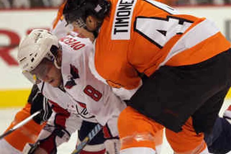 Flyers' Kimmo Timonen and Ian Laperriere sandwich Capitals star Alex Ovechkin in first period.