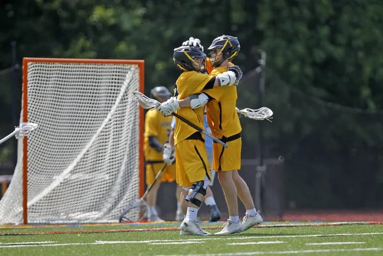 Moorestown’s Trevon Jones, left and Sean Carder celebrate after Jones scored against Shawnee during the second half of the South Jersey Group 3 lacrosse game