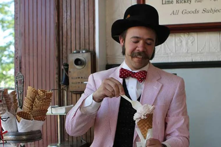 Eric Berley holds a strawberry ice cream waffle cone at the Franklin Fountain, his ice cream shop in Old City.