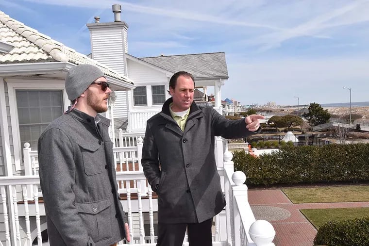 Mike Callahan (left), of Warrington, takes in the view of the Atlantic Ocean from 2029 Wesley Avenue in Ocean City with Realtor Bill Godfrey. Shore towns say rentals are up by 20 percent to 40 percent compared with last year. (GREGG KOHL / For the Inquirer)