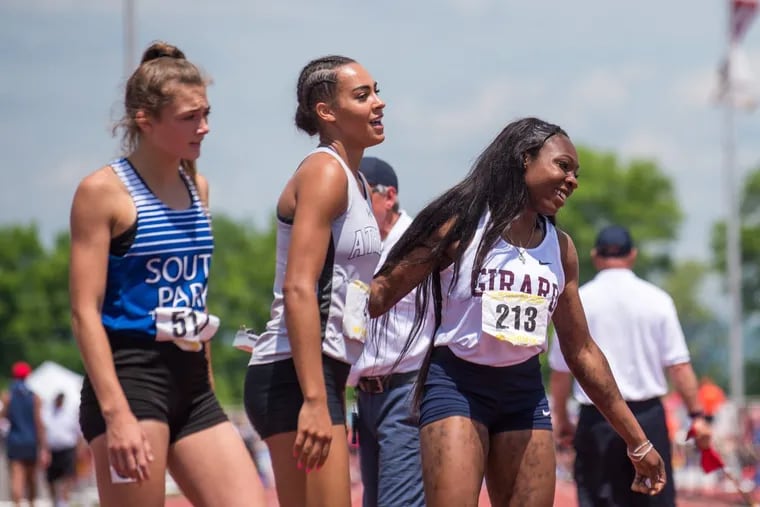 Thelma Davies of Girard College (right) celebrates with Breana Gambrell of Athens (center), who finished second, after Davies won the 2A 100-meter dash. At left is Maddie Raymond of South Park.