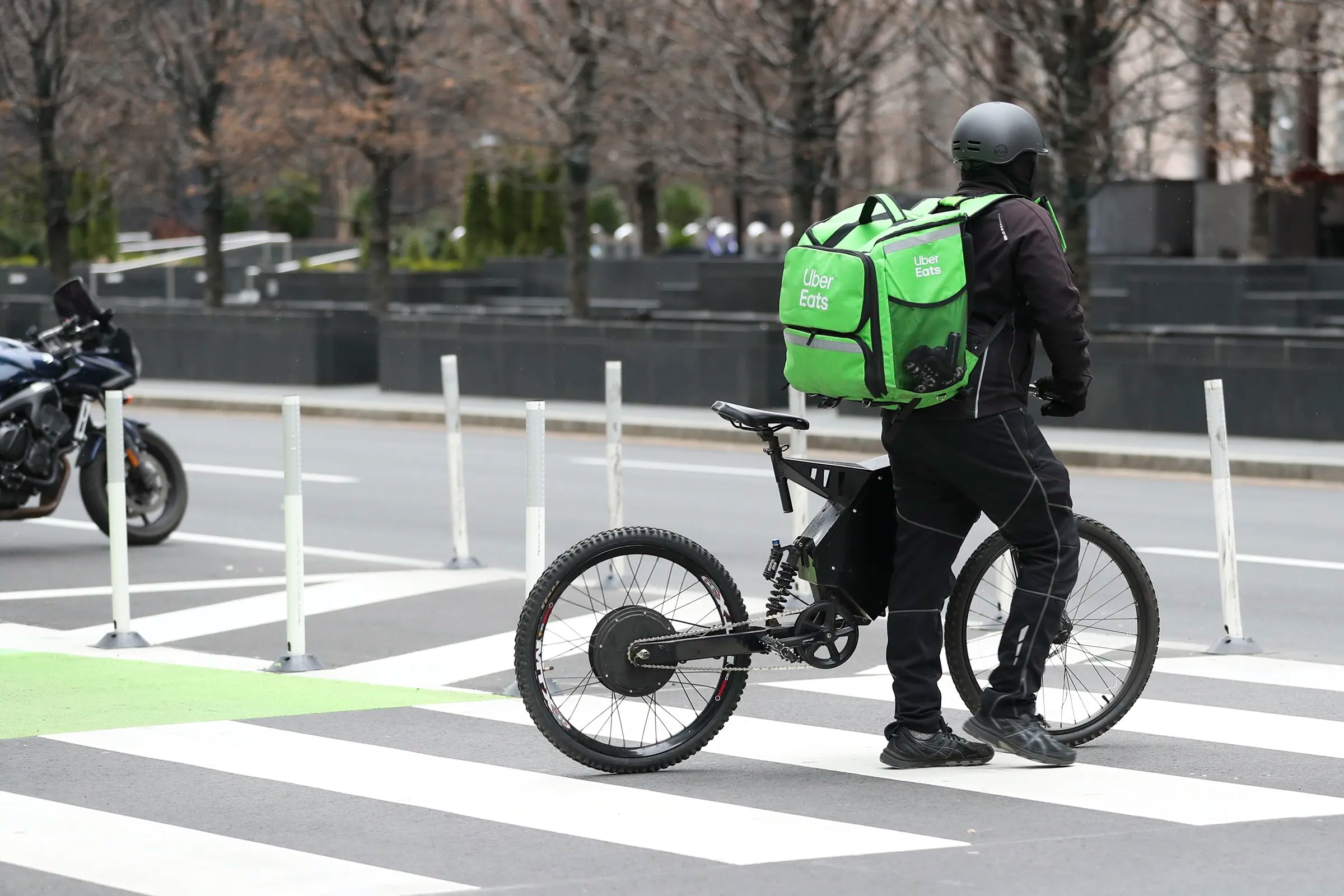 An Uber Eats delivery worker making stops at 17th and JFK Boulevard in Philadelphia in March 2021.