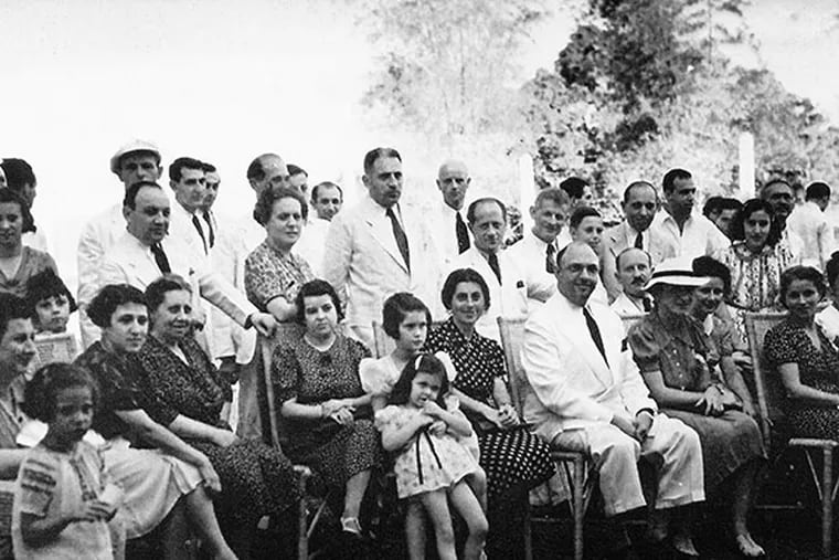 Alex Frieder (seated center) with refugees at a Jewish Community meeting in 1940. (handout photo)