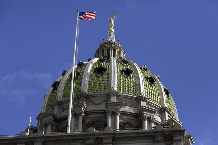 The American flag flies at the Pennsylvania State Capitol building Wednesday Oct. 24, 2018, in Harrisburg, Pa.