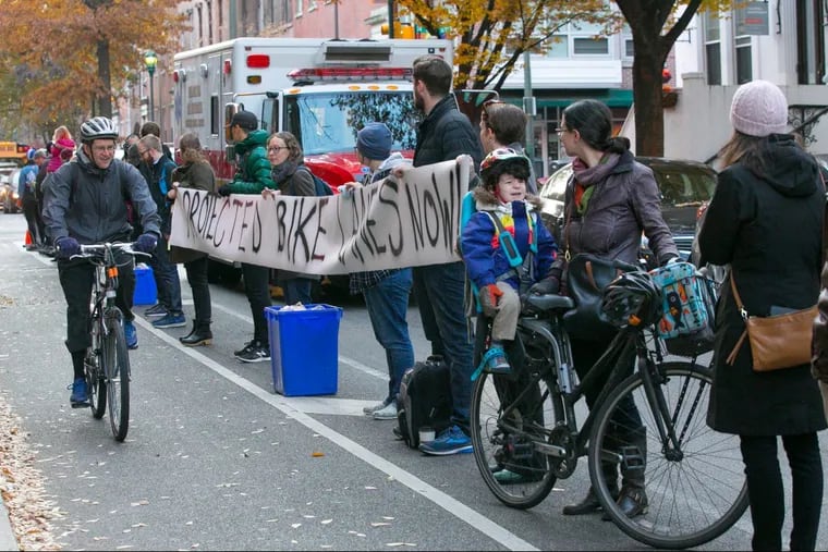 Protesters advocate for safer bike lanes by lining up along 11th and Spruce streets in Philadelphia on Wednesday.