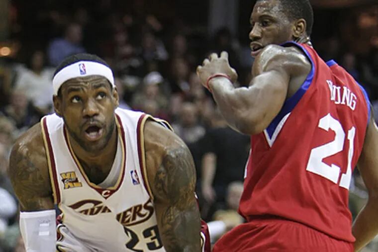 Thaddeus Young defends against LeBron James during the Sixers' 97-91 loss to Cleveland. (AP Photo/Mark Duncan)