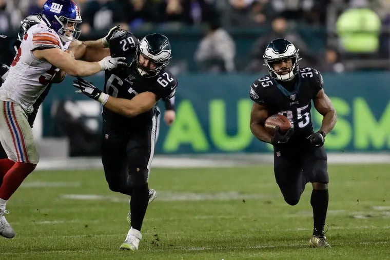 Eagles running back Boston Scott uses a block from center Jason Kelce to pick up some critical yardage in Monday night's come-from-behind win over the Giants.