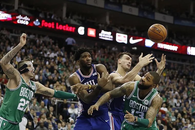 Joel Embiid and Dario Saric go after the ball during the Sixers’ last trip overseas: a matchup vs. the Celtics in London. Philadelphia will play two preseason games against Dallas in China this year.