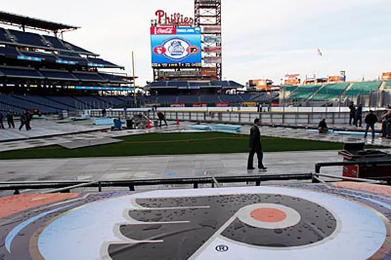 The Flyers logo sits on the Phillies dugout in preparation for the Winter Classic at Citizens Bank Park. (Yong Kim/Staff Photographer)
