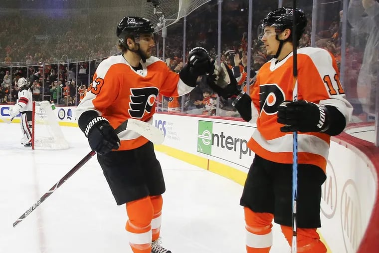 Travis Konecny (right) celebrating his first-period goal with Shayne Gostisbehere in Saturday’s 3-1 win over New Jersey.