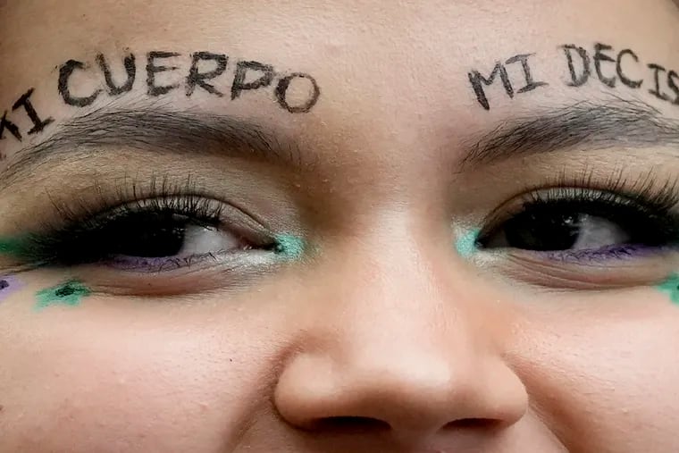 An abortion-rights activist with the message above her eyebrows that reads in Spanish "My body, my decision" attends a rally in Bogota, Colombia, which in February of this year made abortion until the 24th week of pregnancy legal in that country. But many Latina immigrants in the U.S. come from countries where abortion has traditionally been illegal, and so deserve educational outreach about choices available to them here, say Philly Latina leaders.